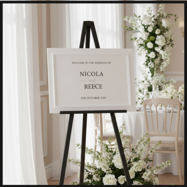 A framed sign on an easel displaying "Nicola Reece" at a wedding venue.