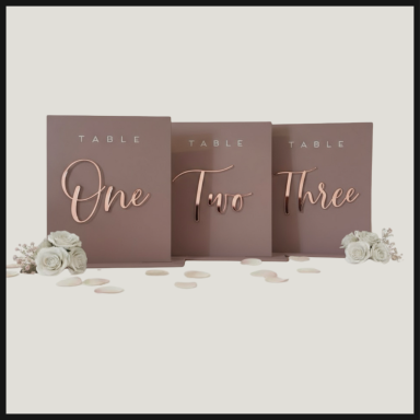 Table numbers One, Two, and Three in elegant script, surrounded by small flowers.