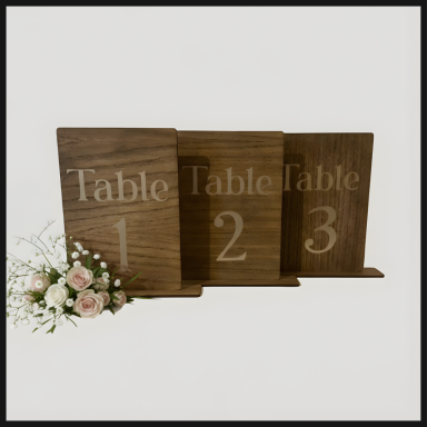 Three wooden table number signs numbered 1, 2, and 3, with a floral arrangement nearby.